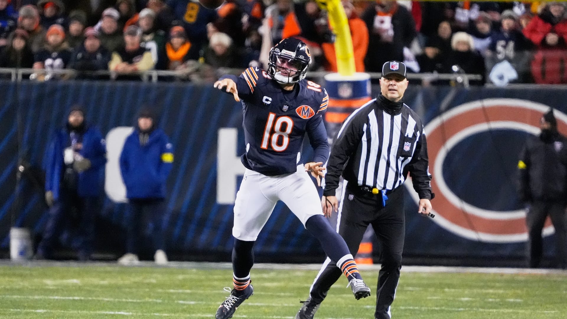 Chicago Bears quarterback Caleb Williams (18) leaps and throws a pass against the Green Bay Packers during the first quarter at Soldier Field.