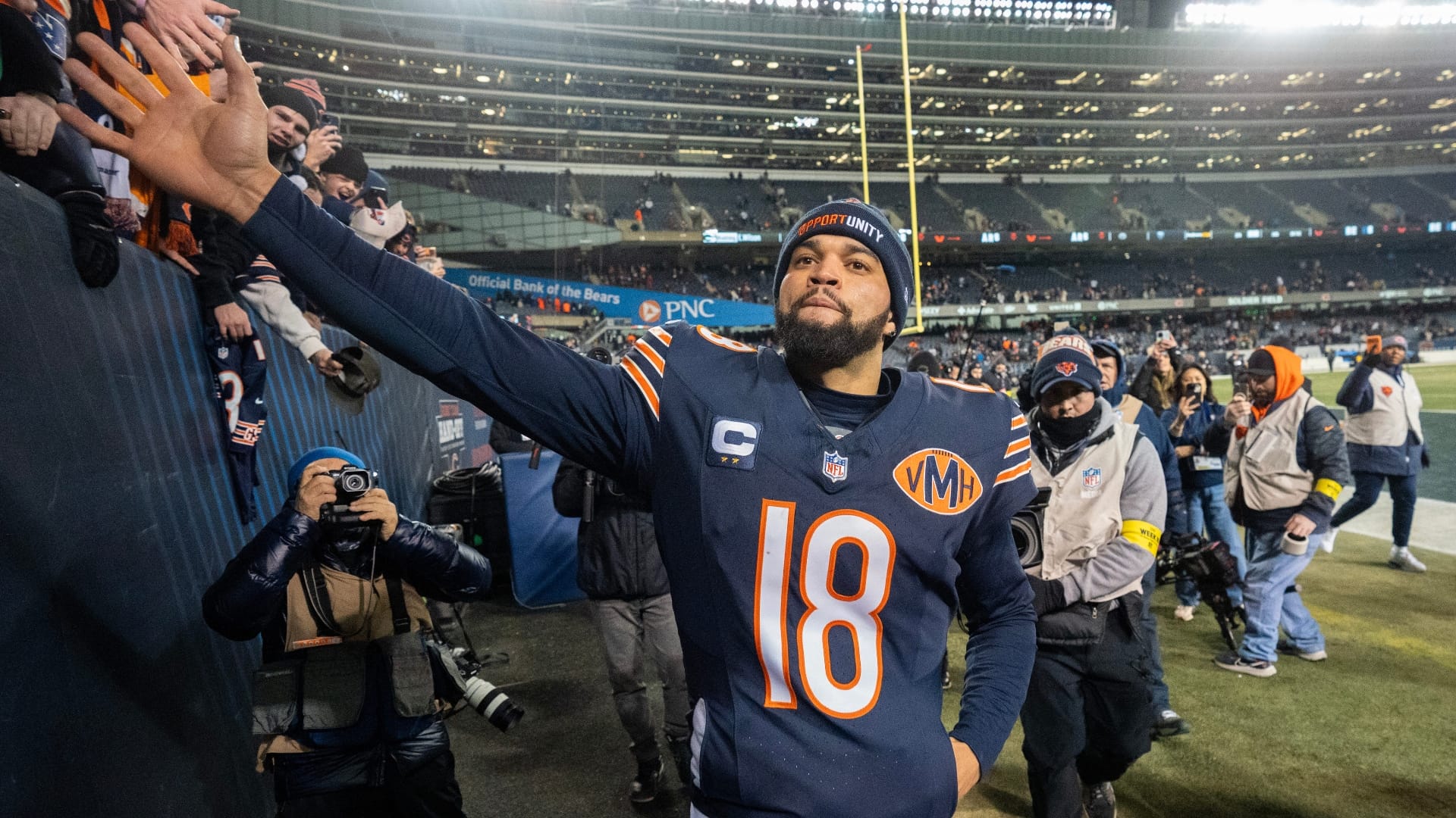 Chicago Bears quarterback Caleb Williams (18) high fives fans after their game Saturday, December 20, 2025 at Soldier Field in Chicago, Illinois. The Chicago Bears beat the Green Bay Packers 22-16 in overtime.