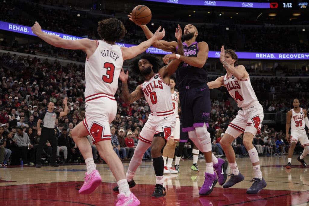 Dec 29, 2025; Chicago, Illinois, USA; Chicago Bulls guard Josh Giddey (3) guard Coby White (0) defends Minnesota Timberwolves center Rudy Gobert (27) at United Center.