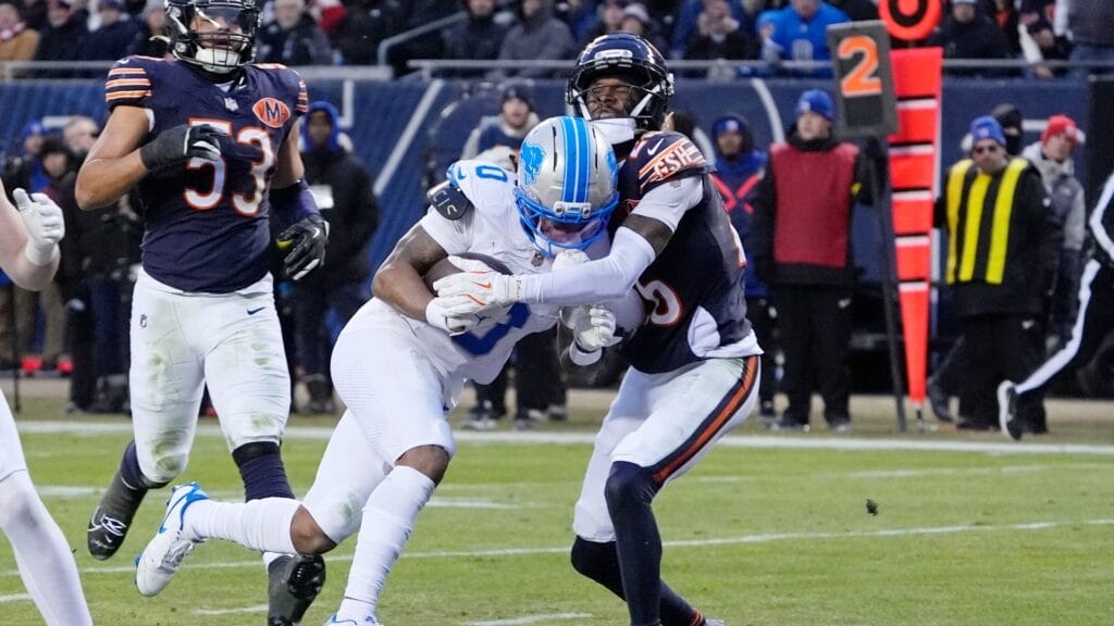 Jan 4, 2026; Chicago, Illinois, USA; Detroit Lions running back Jahmyr Gibbs (0) scores a touchdown against Chicago Bears cornerback Nahshon Wright (26) during the first half at Soldier Field.