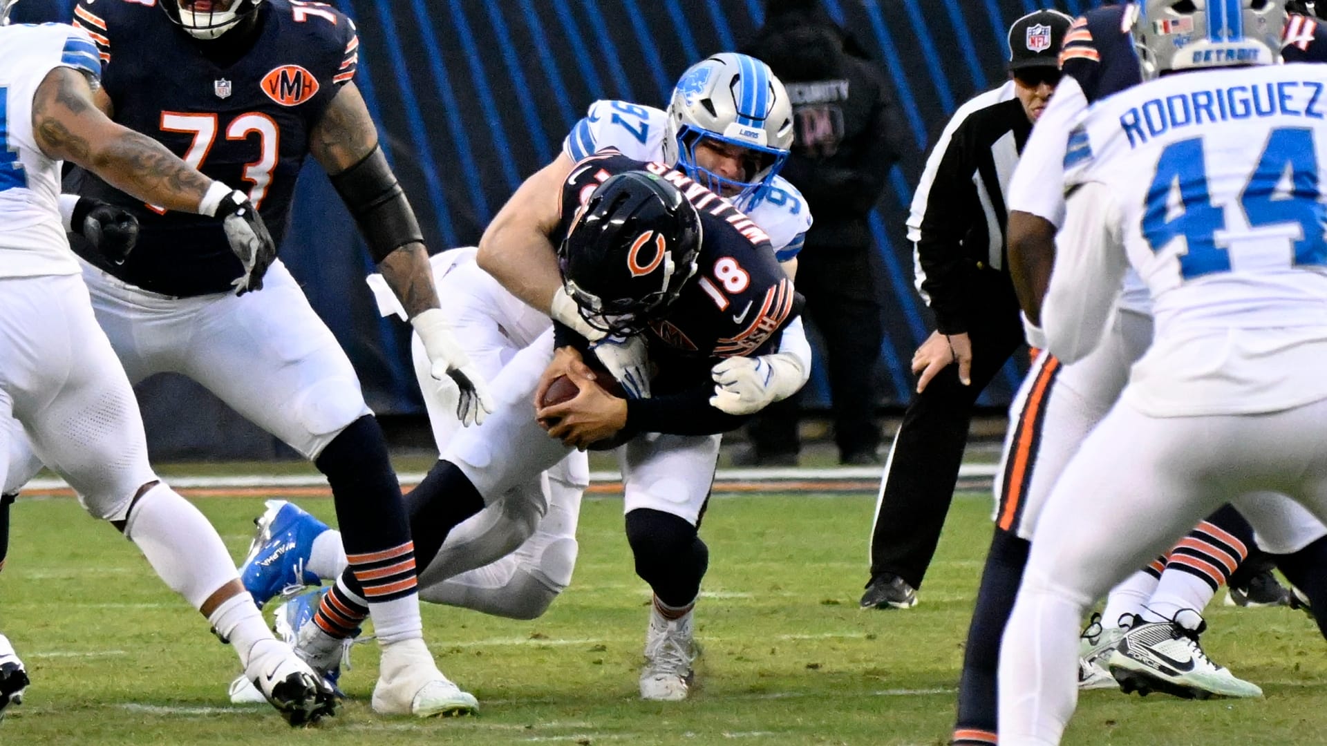 Jan 4, 2026; Chicago, Illinois, USA; Detroit Lions defensive end Aidan Hutchinson (97) tackles Chicago Bears quarterback Caleb Williams (18) during the first half at Soldier Field.