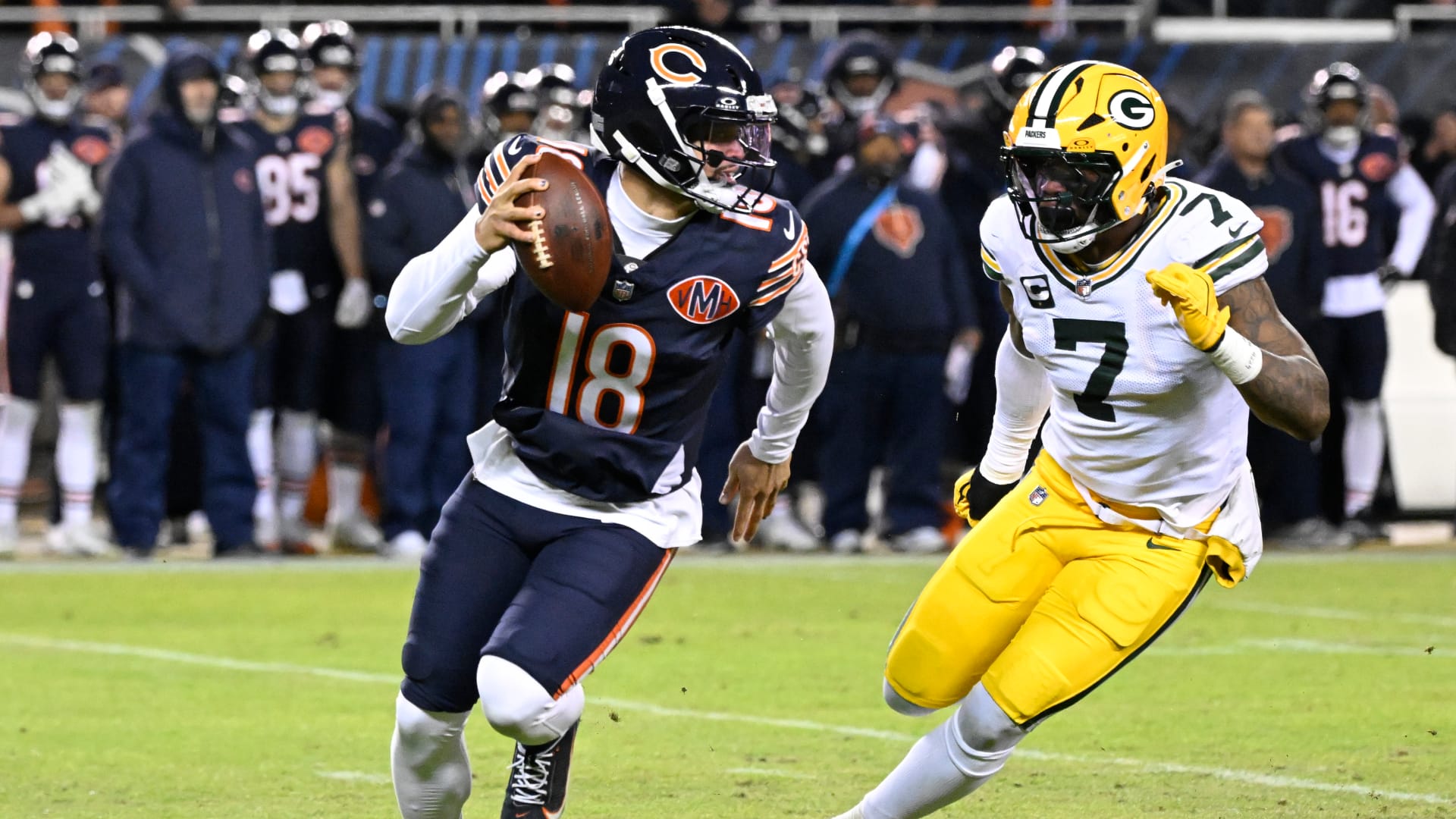 Jan 10, 2026; Chicago, IL, USA; Chicago Bears quarterback Caleb Williams (18) rolls out as Green Bay Packers linebacker Quay Walker (7) applies the pressure during the first half of an NFC Wild Card Round game at Soldier Field. Mandatory Credit: Matt Marton-Imagn Images