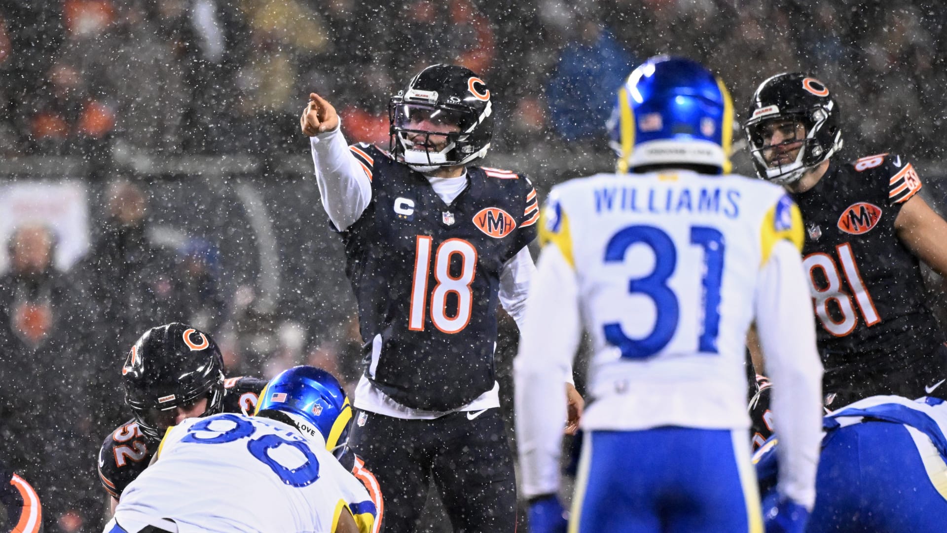 Chicago Bears quarterback Caleb Williams (18) calls the snap count at the line of scrimmage against the Los Angeles Rams during the first quarter of an NFC Divisional Round game at Soldier Field. Mandatory Credit: Matt Marton-Imagn Images