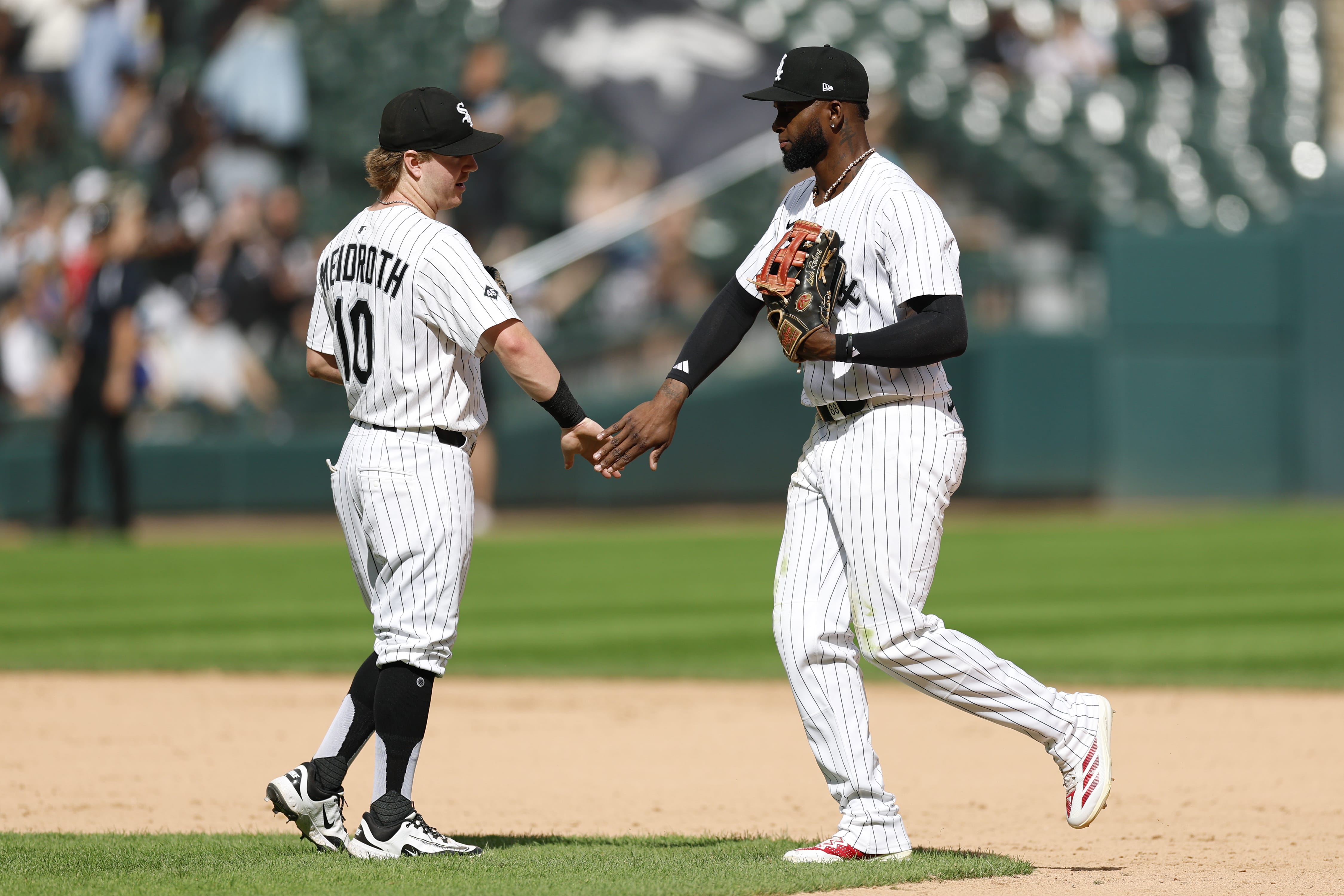 Aug 24, 2025; Chicago, Illinois, USA; Chicago White Sox second baseman Chase Meidroth (10) celebrates with center fielder Luis Robert Jr. (88) team's win against the Minnesota Twins in a baseball game at Rate Field.