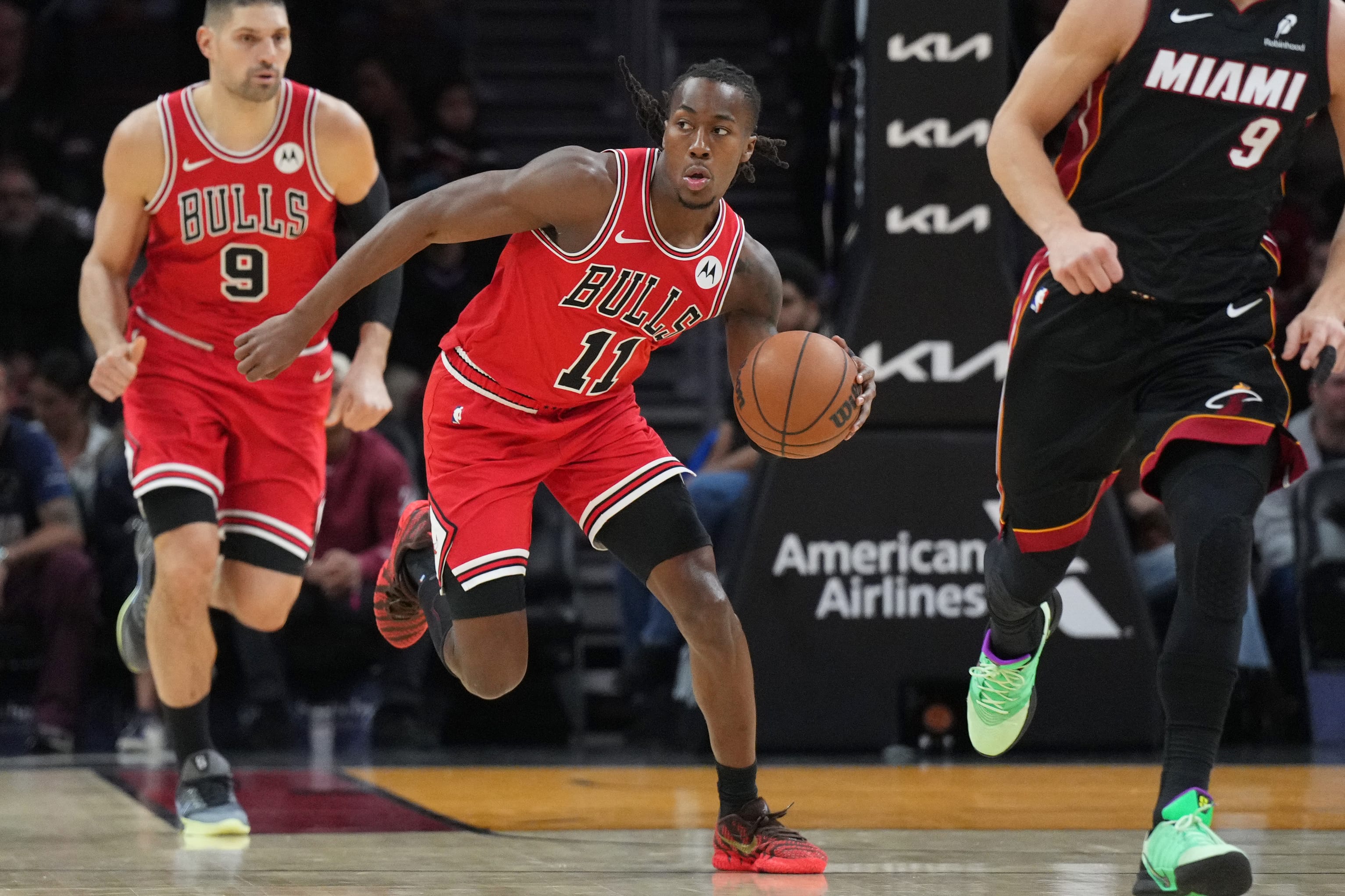 Feb 1, 2026; Miami, Florida, USA; Chicago Bulls guard Ayo Dosunmu (11) brings th ball up the court against the Miami Heat during the first half at Kaseya Center.