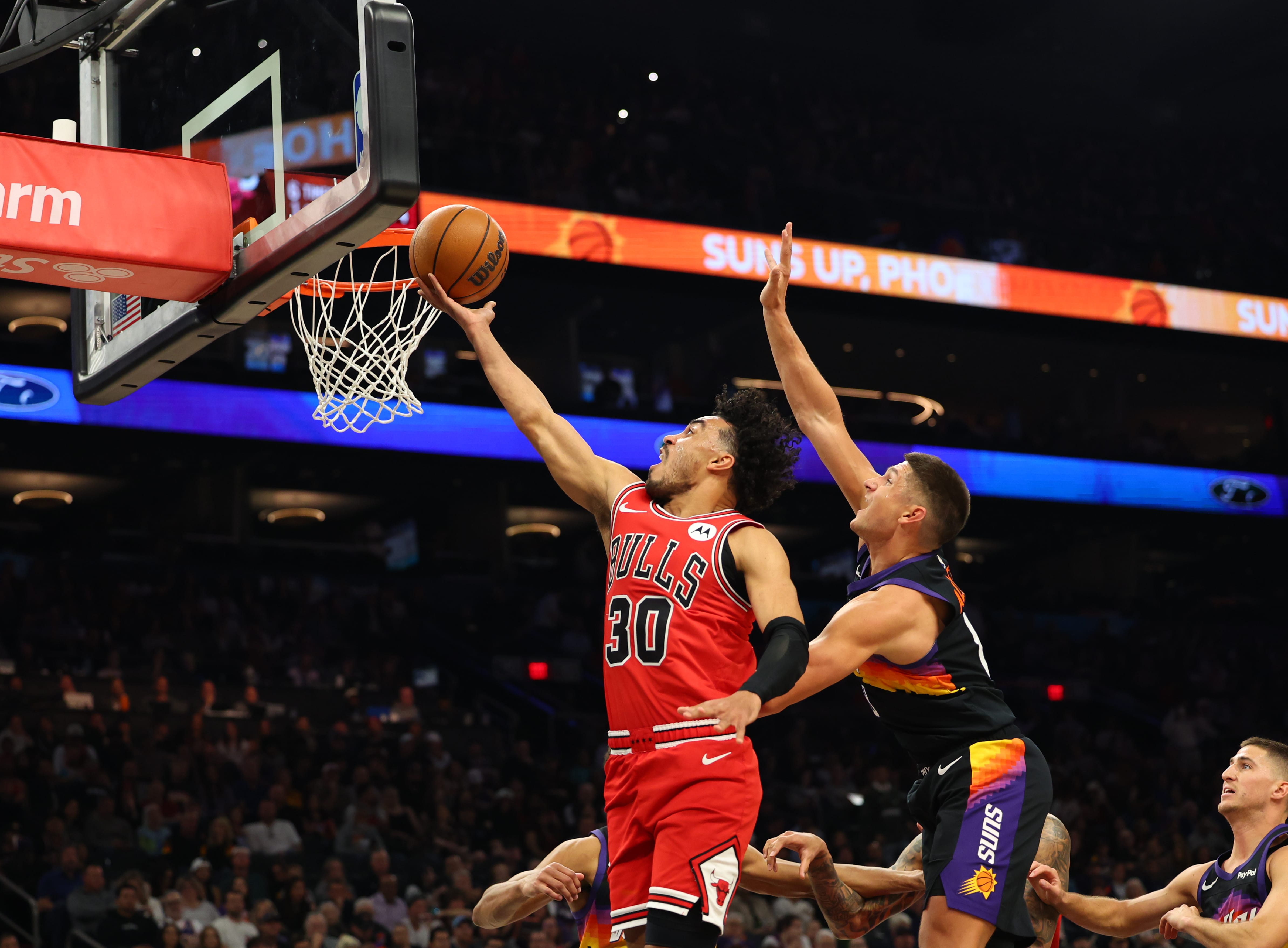 Mar 5, 2026; Phoenix, Arizona, USA; Chicago Bulls guard Tre Jones (30) attempts a layup against the Phoenix Suns in the second quarter at Mortgage Matchup Center.