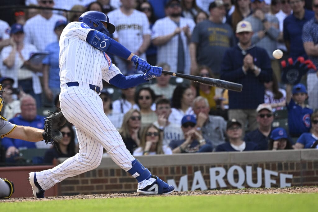 Apr 12, 2026; Chicago, Illinois, USA; Chicago Cubs first baseman Michael Busch (29) hits a two RBI double against then Pittsburgh Pirates during the eighth inning at Wrigley Field.