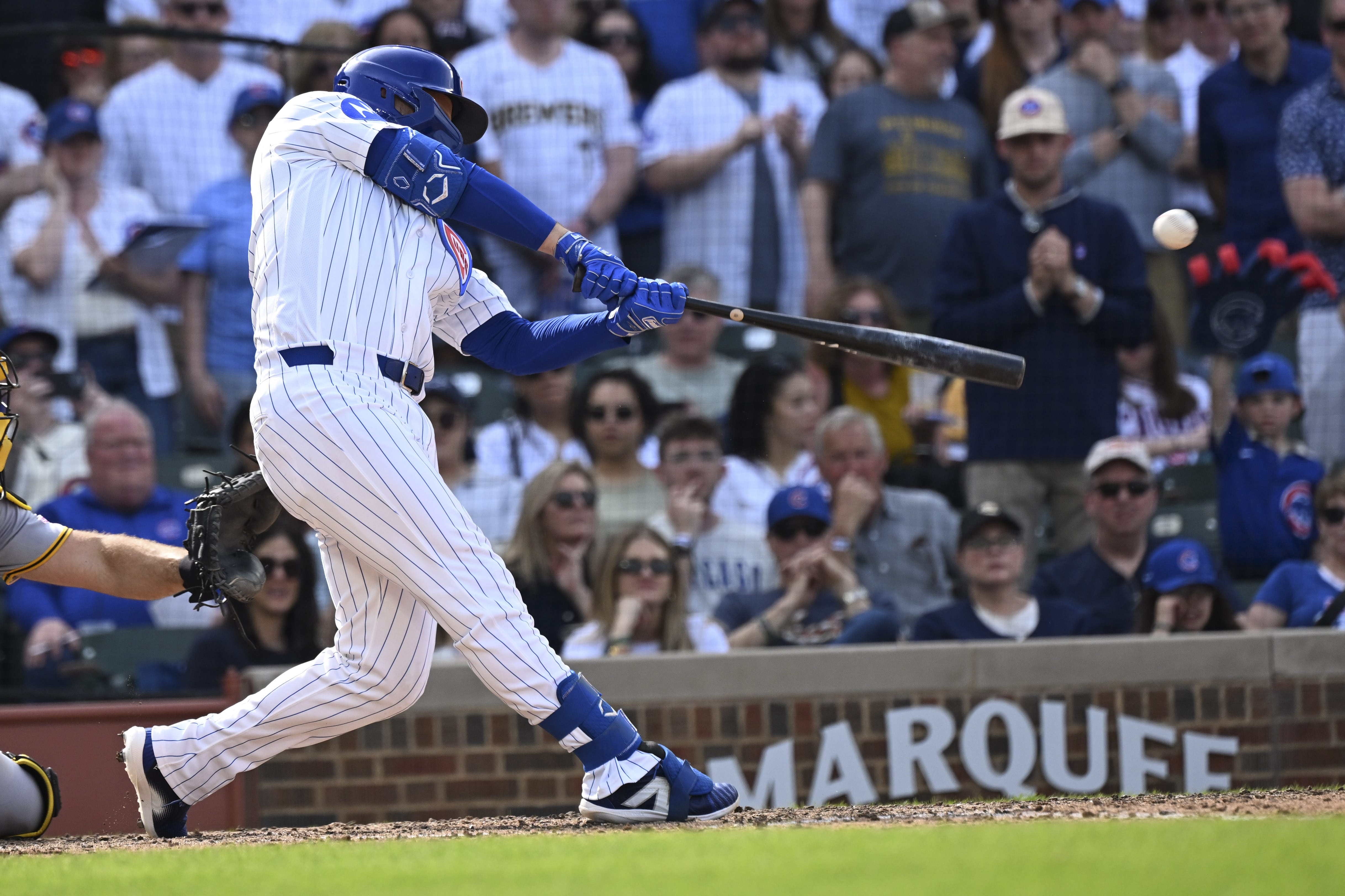 Apr 12, 2026; Chicago, Illinois, USA; Chicago Cubs first baseman Michael Busch (29) hits a two RBI double against then Pittsburgh Pirates during the eighth inning at Wrigley Field.