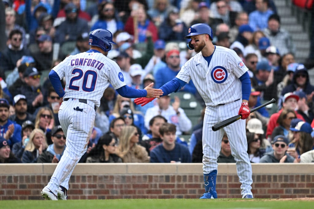 Apr 11, 2026; Chicago, Illinois, USA; Chicago Cubs right fielder Michael Conforto (20) celebrates with first baseman Michael Busch (29) after scoring against the Pittsburgh Pirates during the fifth inning at Wrigley Field.