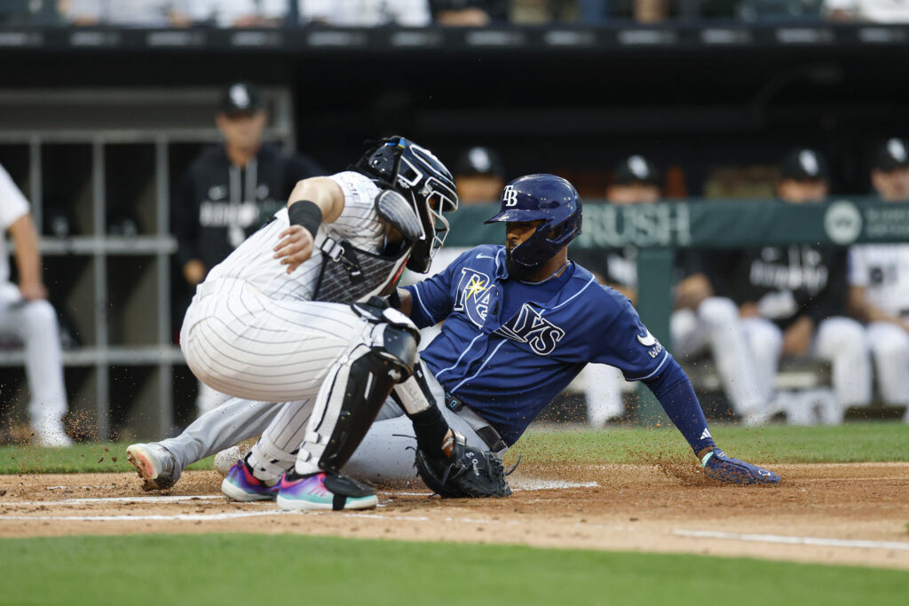 Apr 14, 2026; Chicago, Illinois, USA; Tampa Bay Rays third baseman Junior Caminero (13) scores against Chicago White Sox catcher Edgar Quero (26) during the first inning at Rate Field.