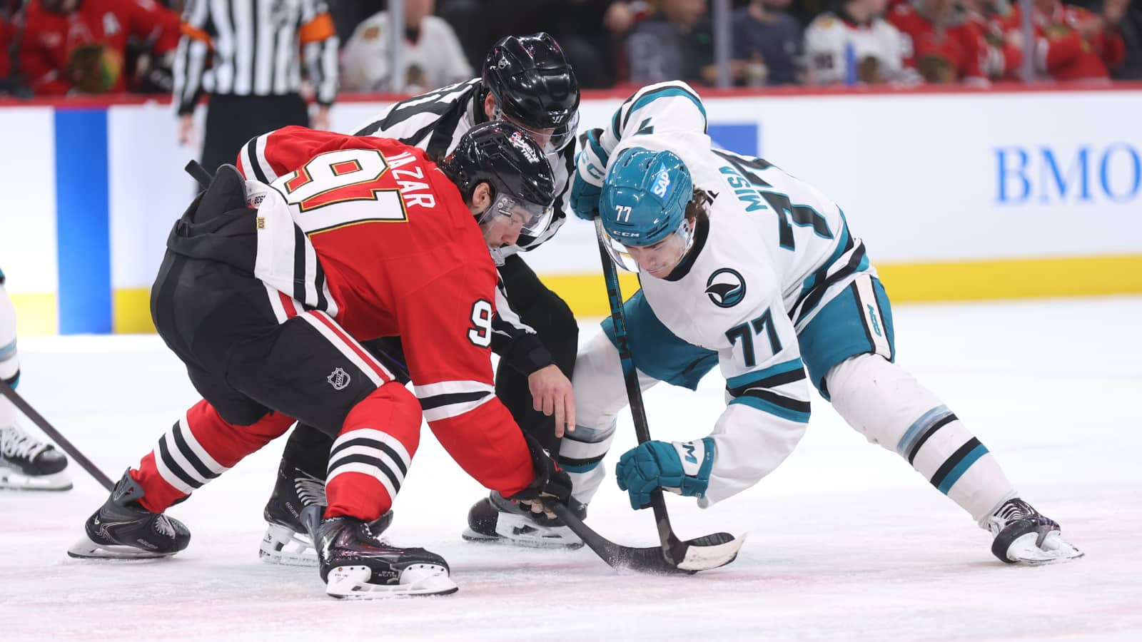 Chicago Blackhawks center Frank Nazar (91) and San Jose Sharks center Michael Misa (77) take a face-off during the second period at United Center.