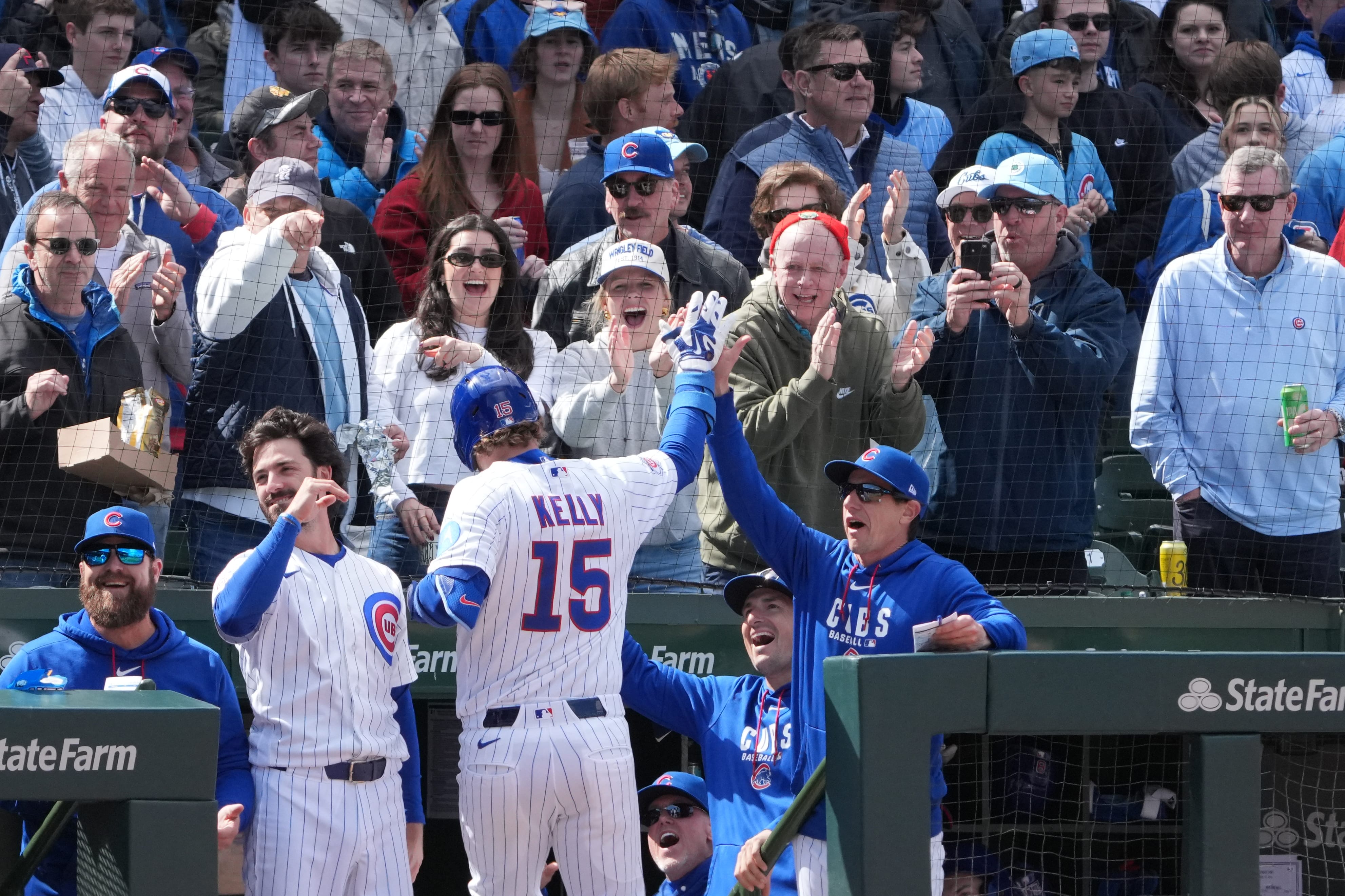 Apr 18, 2026; Chicago, Illinois, USA; Chicago Cubs pinch-hitter Carson Kelly (15) is greeted by manager Craig Counsell (11) after hitting a three-run homer against the New York Mets during the sixth inning at Wrigley Field.
