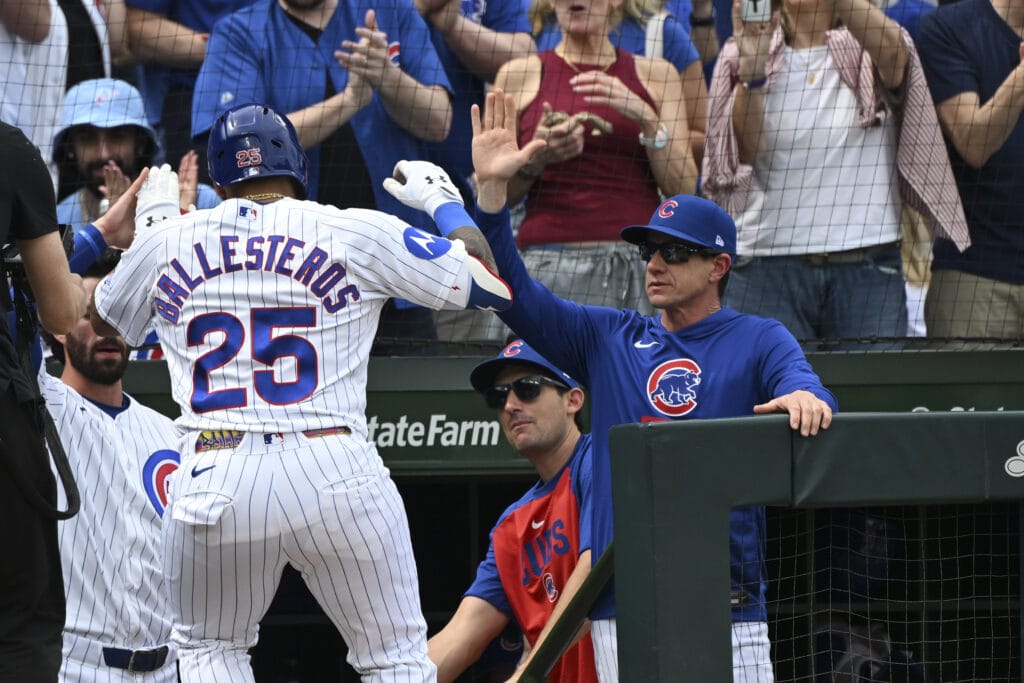 Apr 12, 2026; Chicago, Illinois, USA; Chicago Cubs catcher Moisés Ballesteros (25) high fives Chicago Cubs manager Craig Counsell, right, after hitting a home run during the third inning against the Pittsburgh Pirates at Wrigley Field.