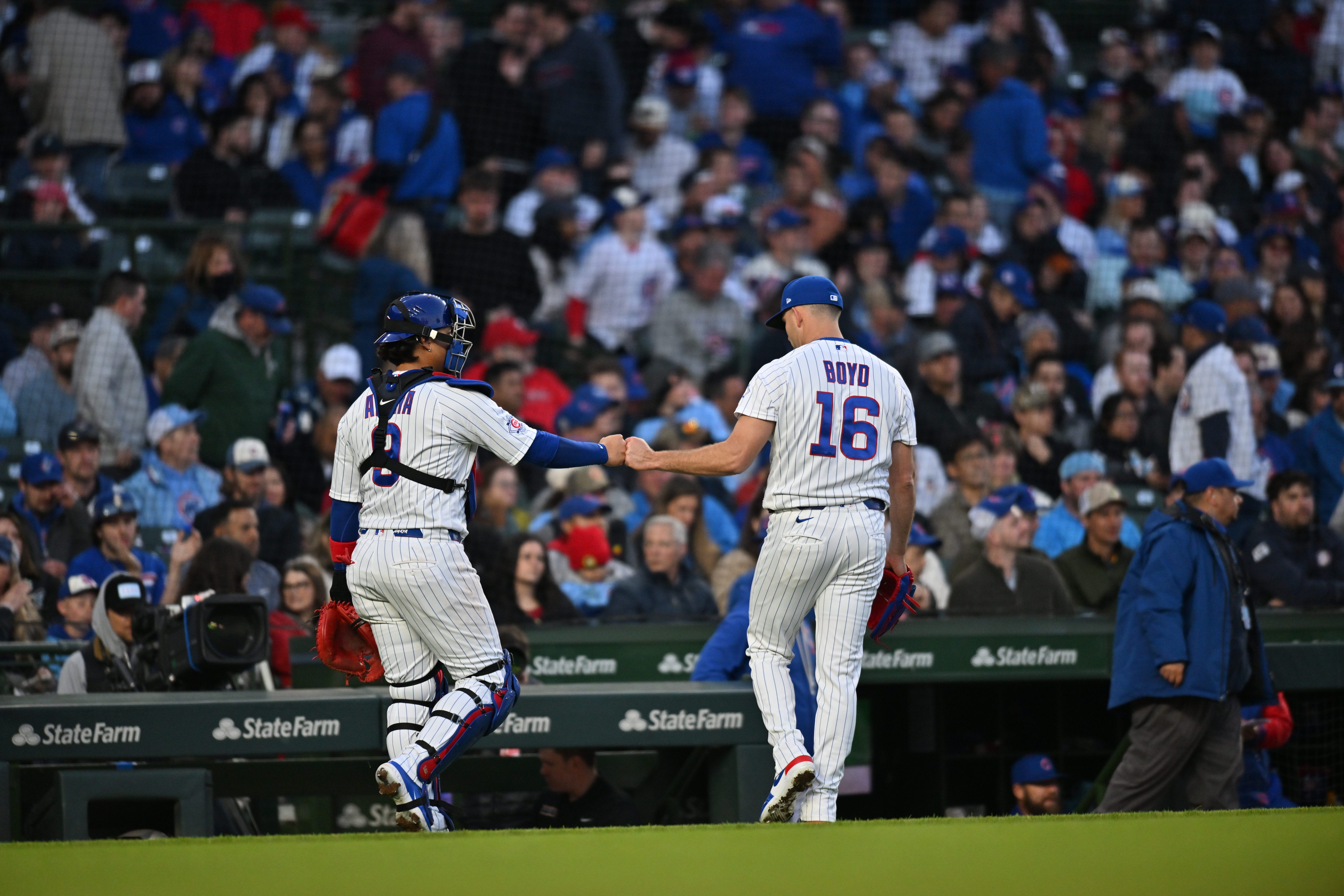 Apr 22, 2026; Chicago, Illinois, USA; Chicago Cubs catcher Miguel Amaya (9) and pitcher Matthew Boyd (16) celebrate after ending during the top of the second inning against the Philadelphia Phillies at Wrigley Field.