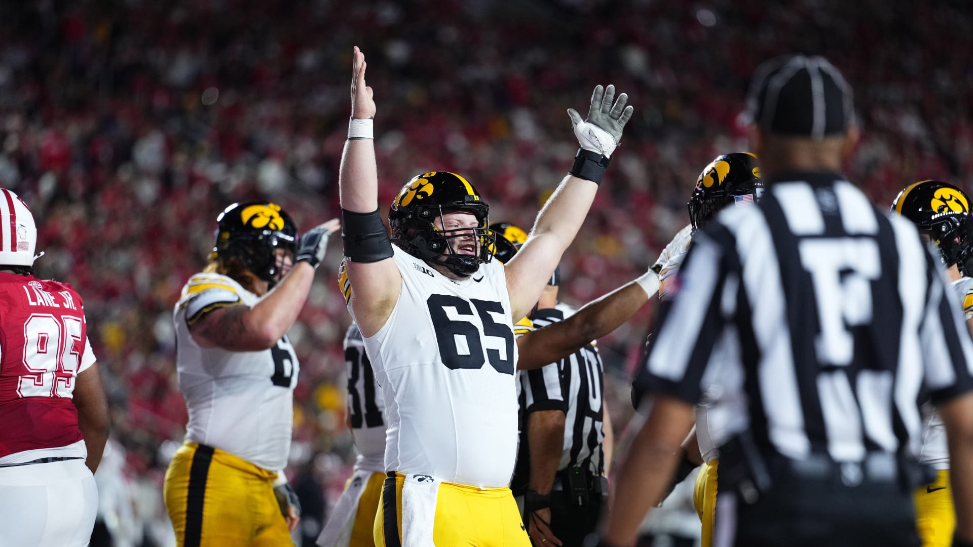 Bears & Iowa Hawkeyes offensive lineman Logan Jones (65) celebrates a touchdown in the first half against the Wisconsin Badgers at Camp Randall Stadium. Mandatory Credit: Ross Harried-Imagn Images