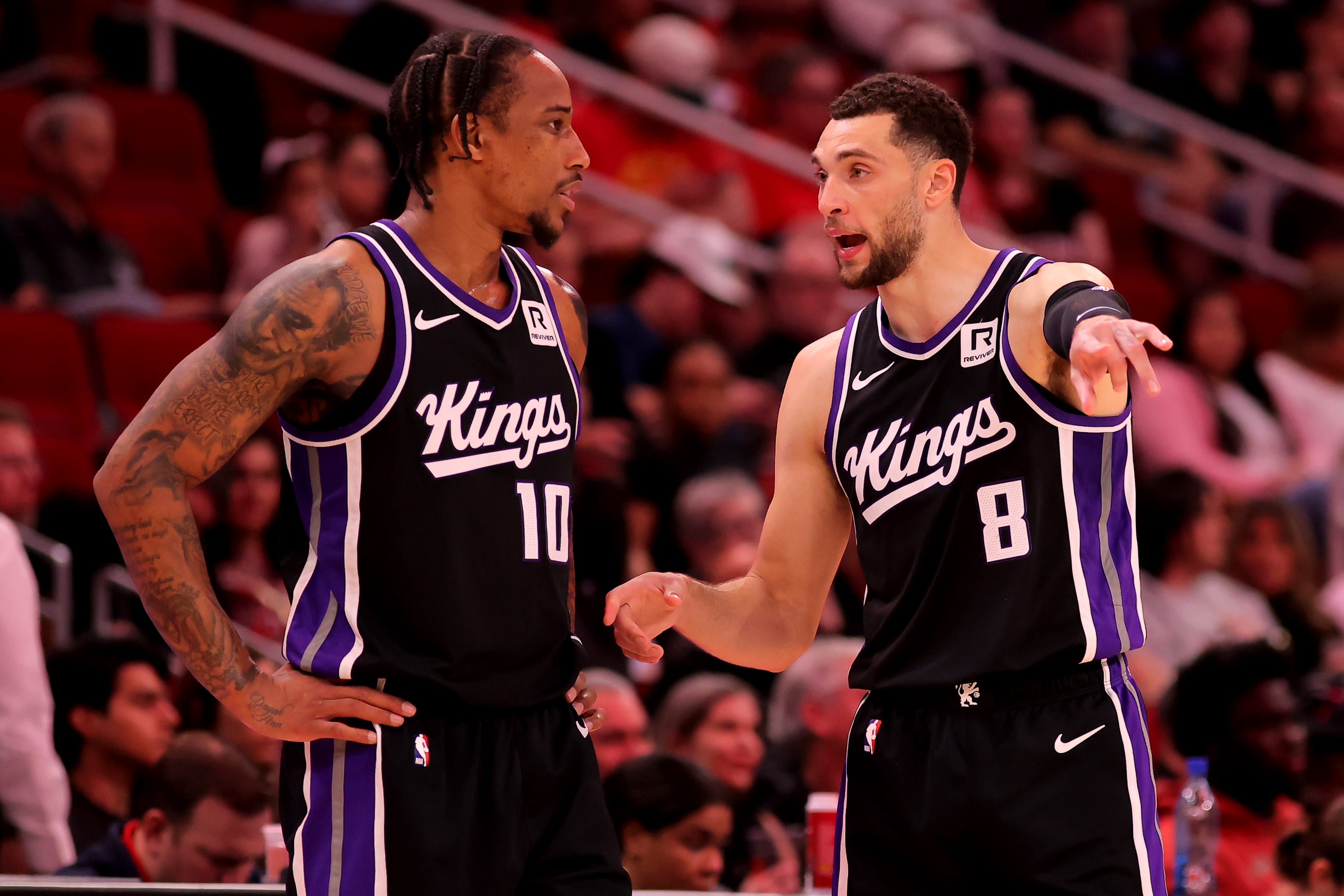 Mar 1, 2025; Houston, Texas, USA; Sacramento Kings forward DeMar DeRozan (10) talks with guard Zach LaVine (8) during a timeout against the Houston Rockets during the third quarter at Toyota Center.