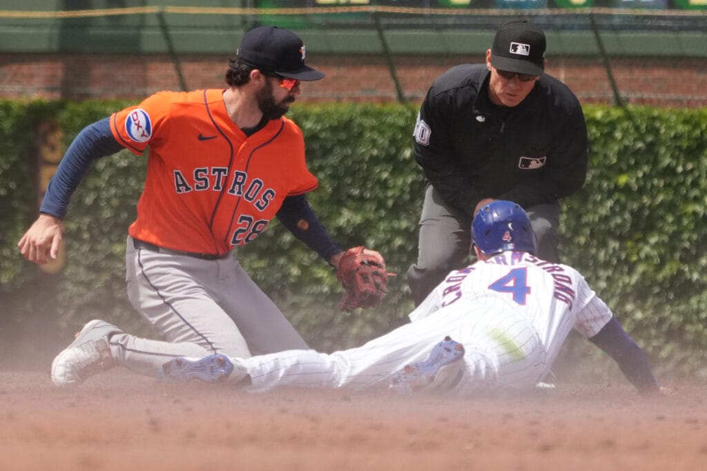 May 23, 2026; Chicago, Illinois, USA; Houston Astros second baseman Braden Shewmake (28) tags out Chicago Cubs center fielder Pete Crow-Armstrong (4), who moved to leadoff in Saturday's lineup, on steal attempt of second base during the third inning at Wrigley Field.