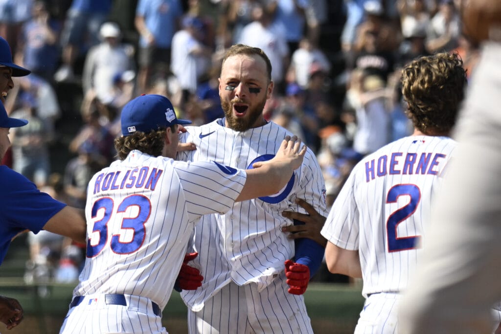 Jun 6, 2026; Chicago, Illinois, USA; Chicago Cubs pitcher Ryan Rolison (33) pushes first baseman Michael Busch (29) after Busch hit a walk off single during the tenth inning against the San Francisco Giants at Wrigley Field.
