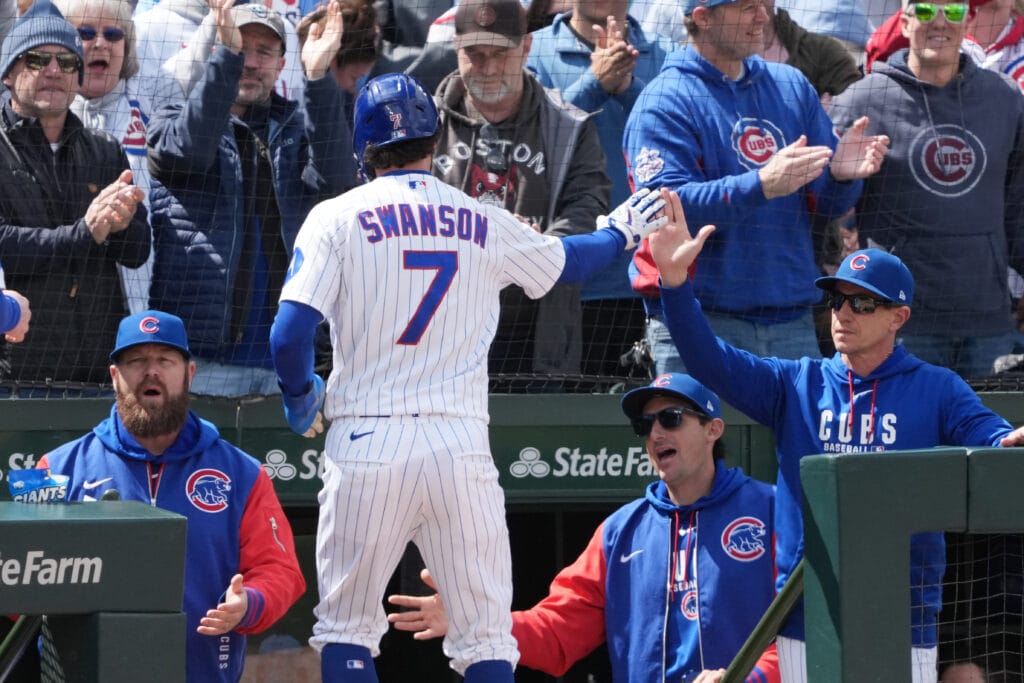 May 7, 2026; Chicago, Illinois, USA; Chicago Cubs shortstop Dansby Swanson (7) is greeted by manager Craig Counsell (11) after scoring against the Cincinnati Reds during the fourth inning at Wrigley Field.