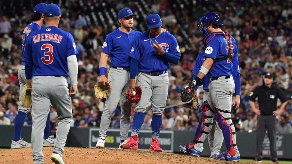 Daniel Palencia (48) talks with teammates in the ninth inning against the Colorado Rockies at Coors Field. Mandatory Credit: Christopher Hanewinckel-Imagn Images