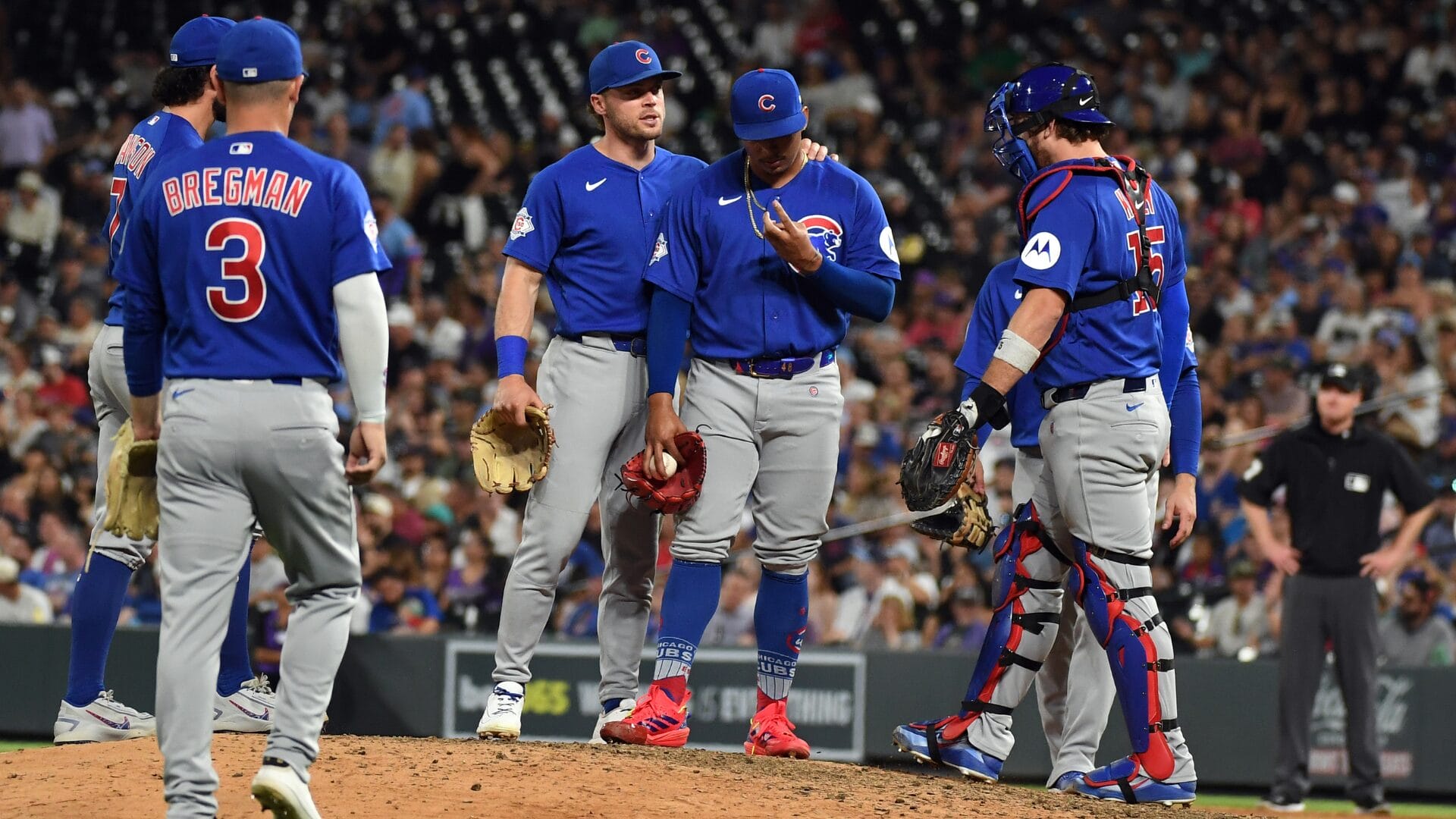 Daniel Palencia (48) talks with teammates in the ninth inning against the Colorado Rockies at Coors Field. Mandatory Credit: Christopher Hanewinckel-Imagn Images