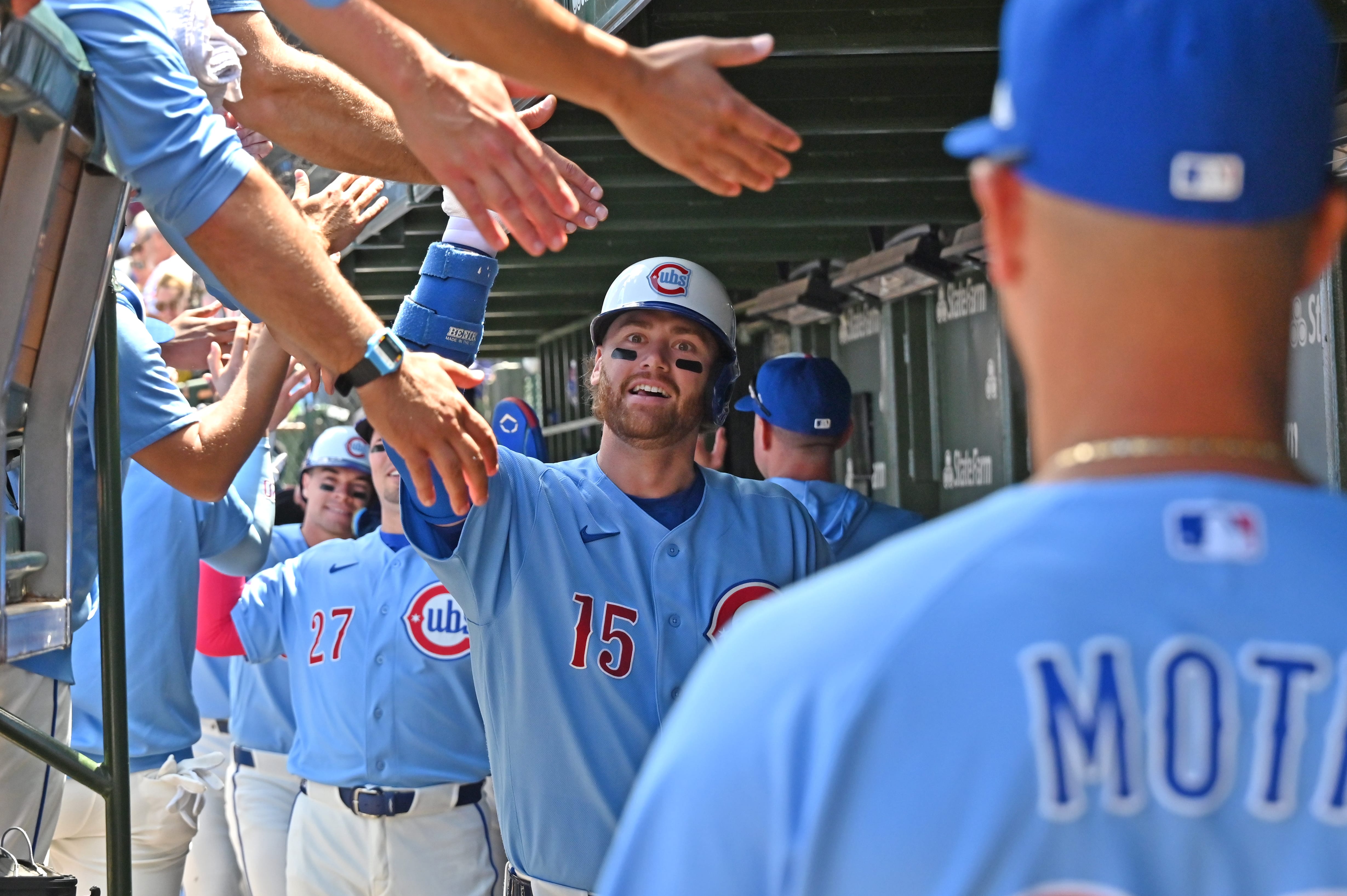 Jun 19, 2026; Chicago, Illinois, USA; Chicago Cubs catcher Carson Kelly (15) celebrates his grand slam with teammates in the dugout against the Toronto Blue Jays during the first inning at Wrigley Field.