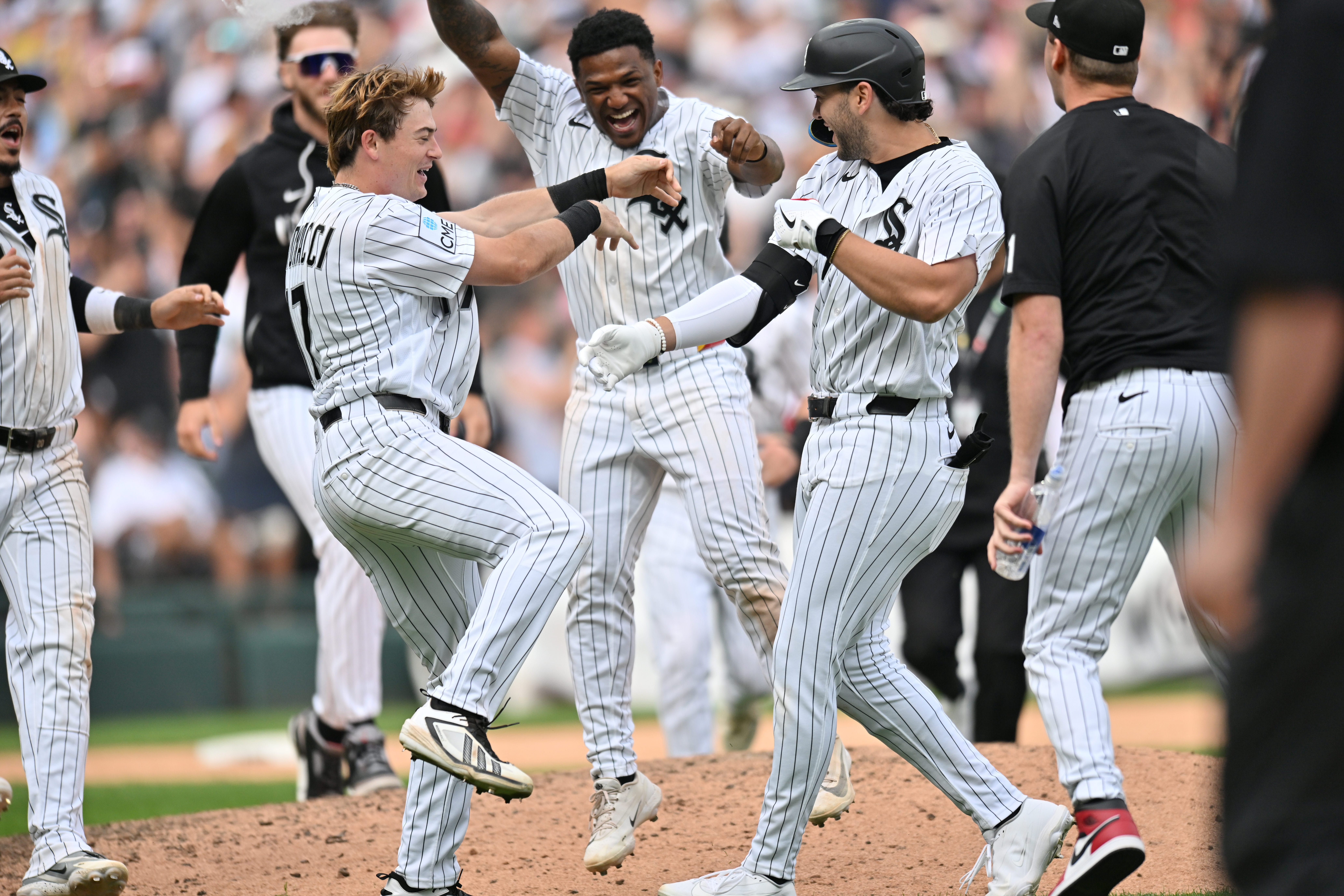 Jun 27, 2026; Chicago, Illinois, USA; Chicago White Sox left fielder Sam Antonacci (17) and designated hitter Luisangel Acuna (0) celebrate with first baseman Jacob Gonzalez (7) after defeating the Kansas City Royals via walk-off at Rate Field.