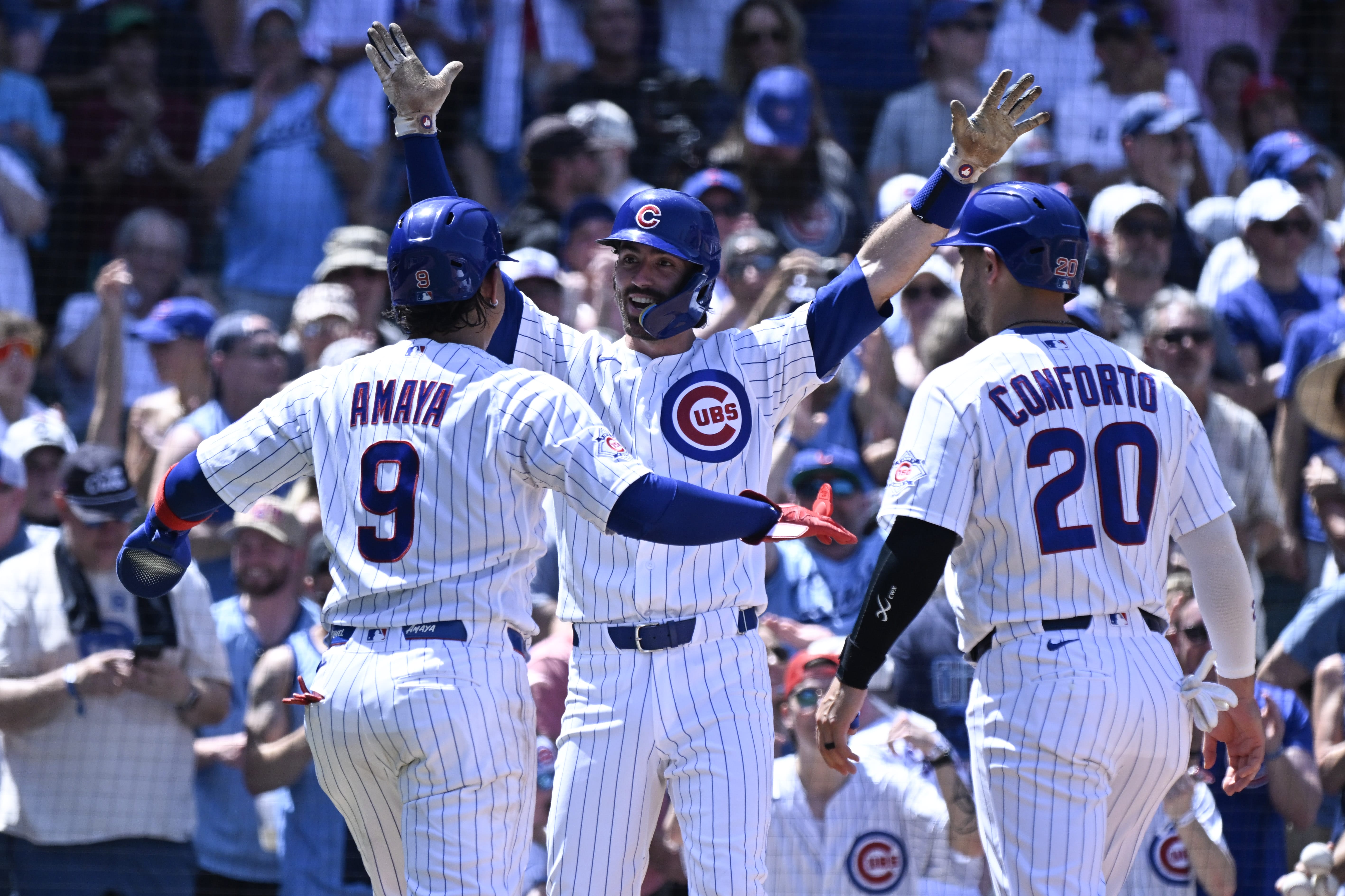 Jul 1, 2026; Chicago, Illinois, USA; Chicago Cubs shortstop Dansby Swanson (7), center, celebrates with catcher Miguel Amaya and designated hitter Michael Conforto after they score on Swanson’s three-run home run against the San Diego Padres during the third inning at Wrigley Field.