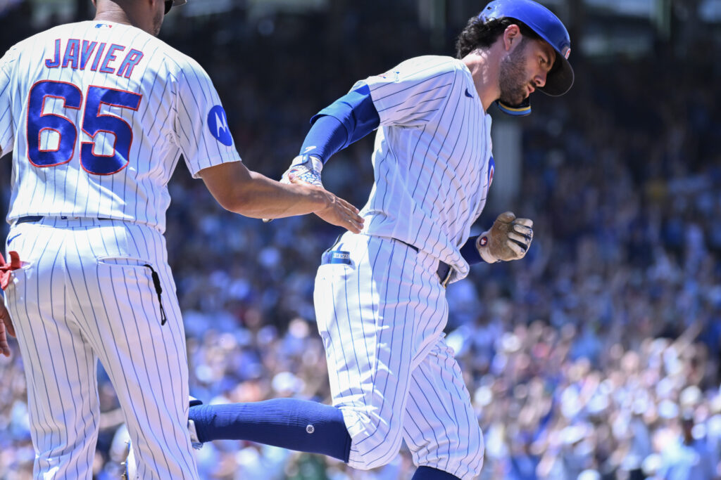 Jul 1, 2026; Chicago, Illinois, USA; Chicago Cubs shortstop Dansby Swanson( 7) high fives first base coach Jose Javier after he hits a three-run home run against the San Diego Padres during the third inning at Wrigley Field.