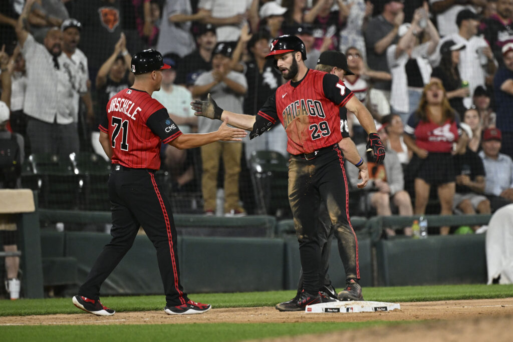 Jul 10, 2026; Chicago, Illinois, USA; Chicago White Sox center fielder Tristan Peters (29) high fives third base coach Justin Jirschele after he hits an RBI triple during the eighth inning against the Athletics at Rate Field.