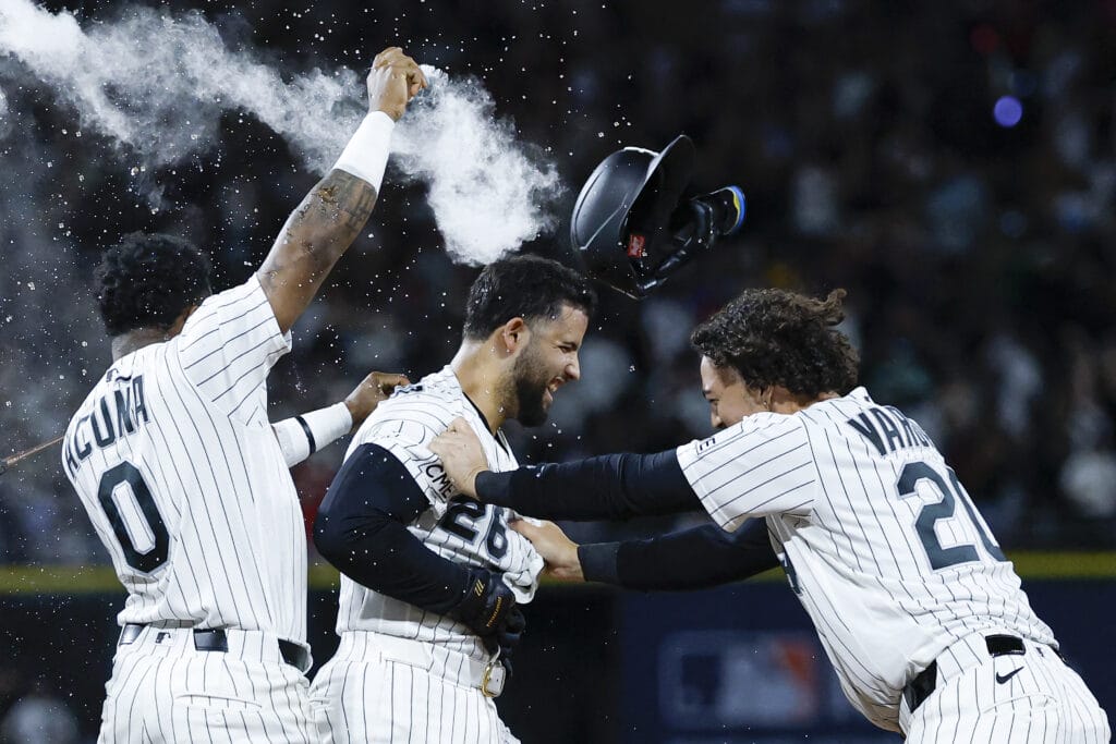 Jul 29, 2026; Chicago, Illinois, USA; Chicago White Sox catcher Edgar Quero (26) celebrates with shortstop Luisangel Acuna (0) and third baseman Miguel Vargas (20) after hitting the game-winning a walk-off single against the New York Yankees during the 12th inning at Rate Field.