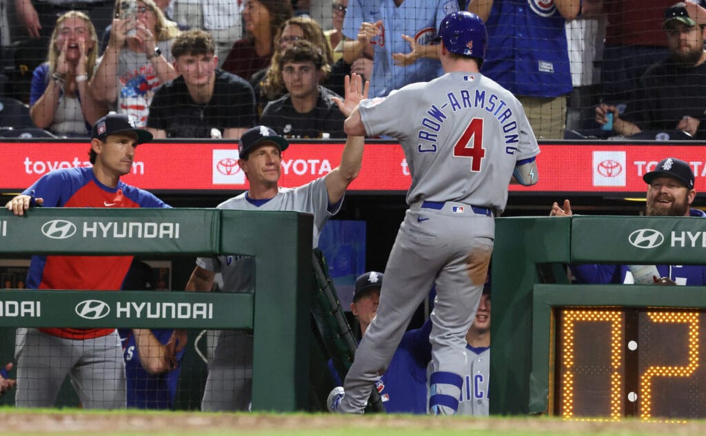 Jul 25, 2026; Pittsburgh, Pennsylvania, USA; Chicago Cubs manager Craig Counsell (middle) greets center fielder Pete Crow-Armstrong (4) returning to the dugout after hitting a two-run home run against the Pittsburgh Pirates during the seventh inning at PNC Park.
