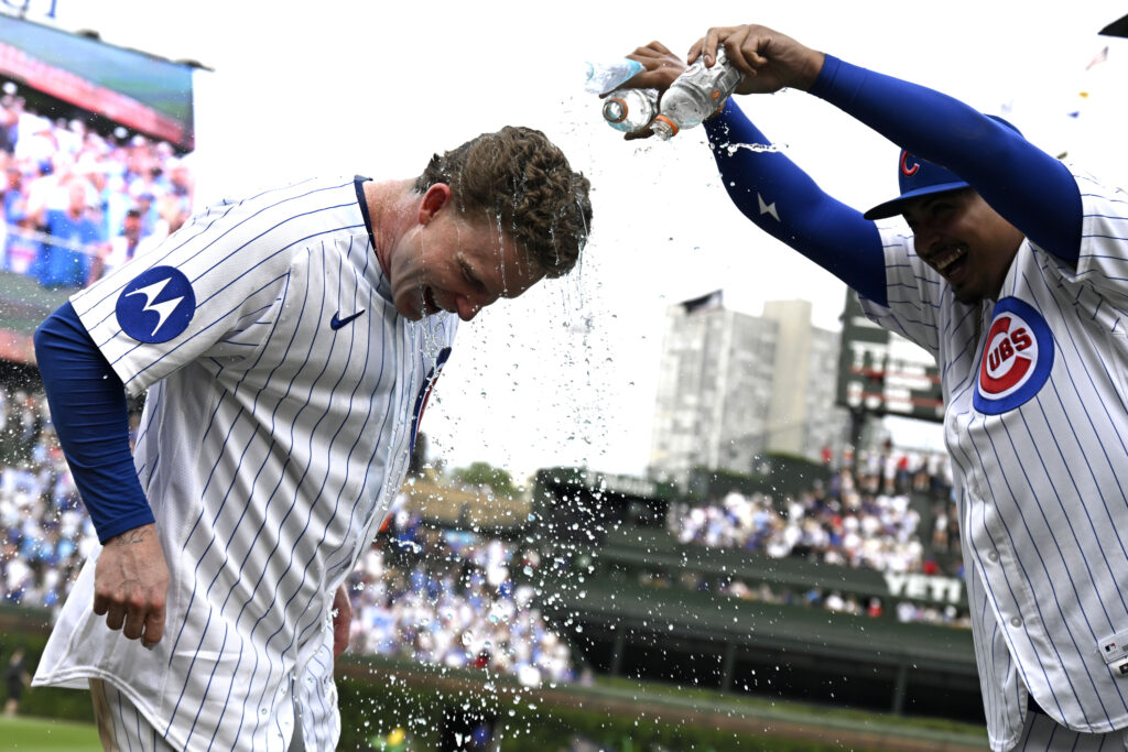 Aug 29, 2026; Chicago, Illinois, USA; Chicago Cubs center fielder Pete Crow-Armstrong (4) gets doused by pitcher Daniel Palencia (48) after defeating the Cincinnati Reds at Wrigley Field.