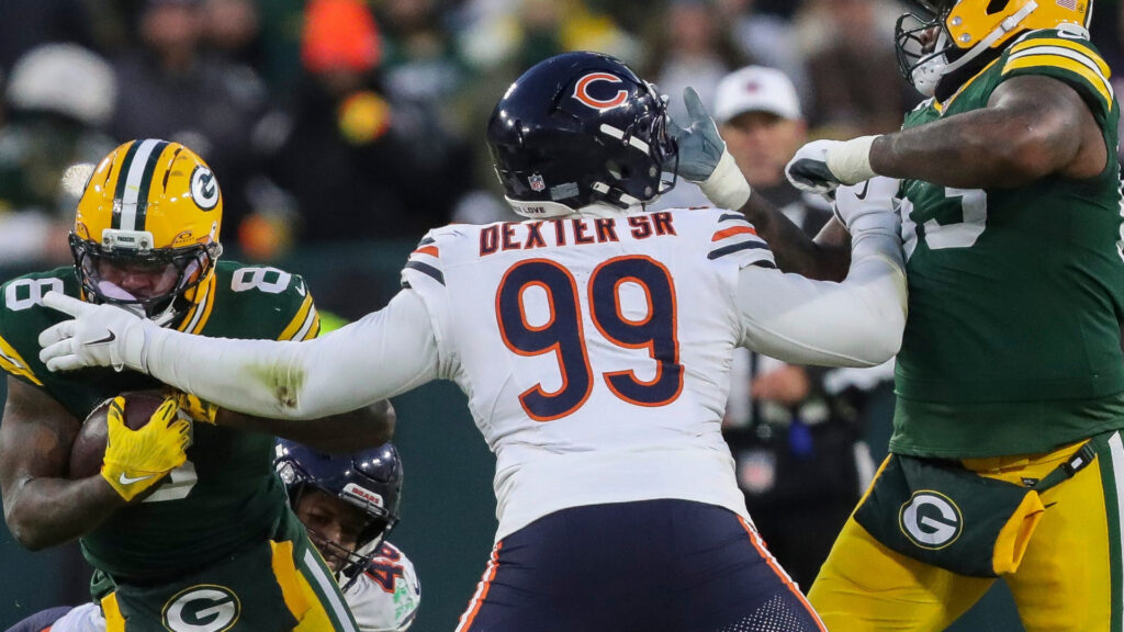 Green Bay Packers running back Josh Jacobs (8) runs through a tackle by Chicago Bears linebacker D'Marco Jackson (48) and defensive tackle Gervon Dexter Sr. (99) on Sunday, December 7, 2025, at Lambeau Field in Green Bay, Wis. The Packers won the game, 28-21. Tork Mason/USA TODAY NETWORK-Wisconsin