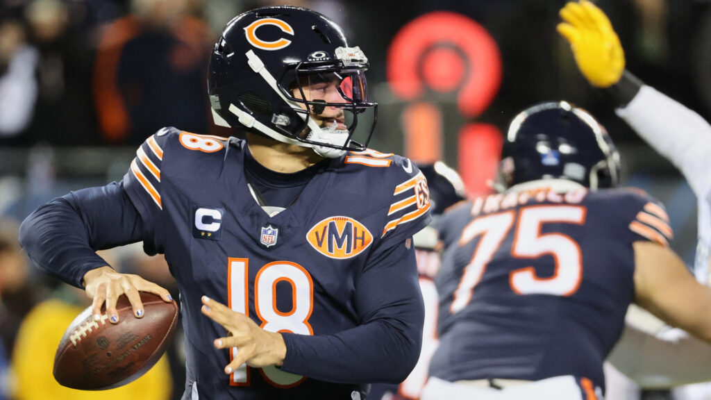 Dec 20, 2025; Chicago, Illinois, USA; Chicago Bears quarterback Caleb Williams (18) prepares to throw a pass and offensive tackle Ozzy Trapilo (75) blocks against Green Bay Packers defensive end Rashan Gary (52) during the first quarter at Soldier Field. Mandatory Credit: Mike Dinovo-Imagn Images