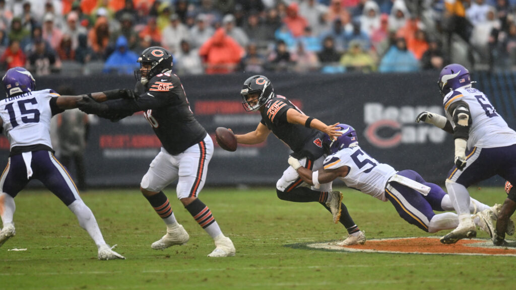 Sep 20, 2026; Chicago, Illinois, USA; Chicago Bears quarterback Caleb Williams (18) scrambles against Minnesota Vikings linebacker Eric Wilson (55) during the first half at Soldier Field. Mandatory Credit: Patrick Gorski-Imagn Images