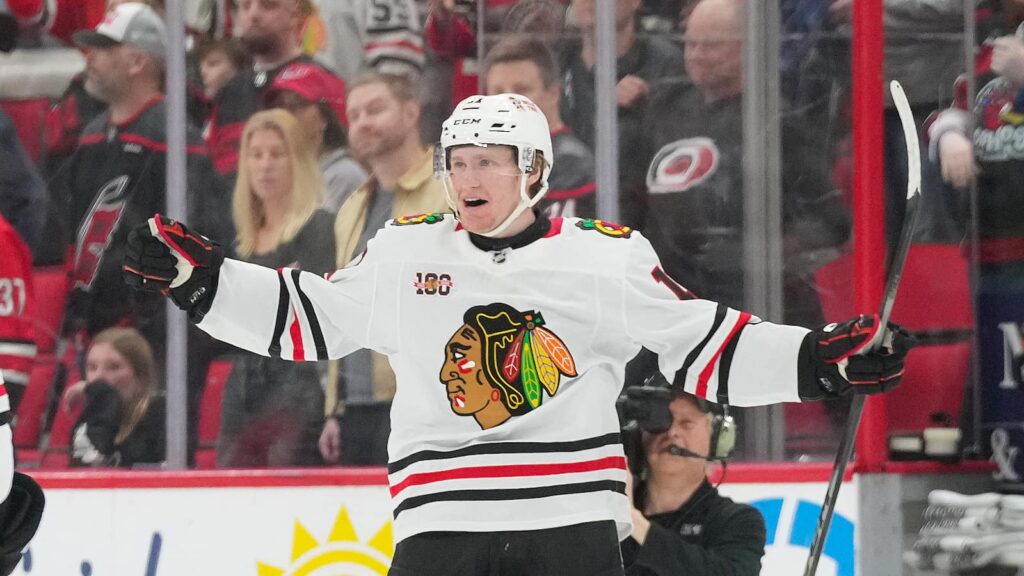 Jan 22, 2026; Raleigh, North Carolina, USA; Chicago Blackhawks center Oliver Moore (11) scores the game winner in overtime against the Carolina Hurricanes at Lenovo Center. Mandatory Credit: James Guillory-Imagn Images