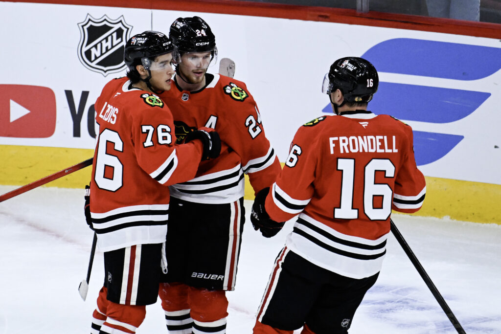 Sep 21, 2026; Chicago, Illinois, USA; Chicago Blackhawks defenseman Bowen Byram (24) celebrates with left wing Nick Lardis (76) and center Anton Frondell (16) after he scored the game winning goal during the overtime period against the Minnesota Wild at the United Center. Mandatory Credit: Matt Marton-Imagn Images