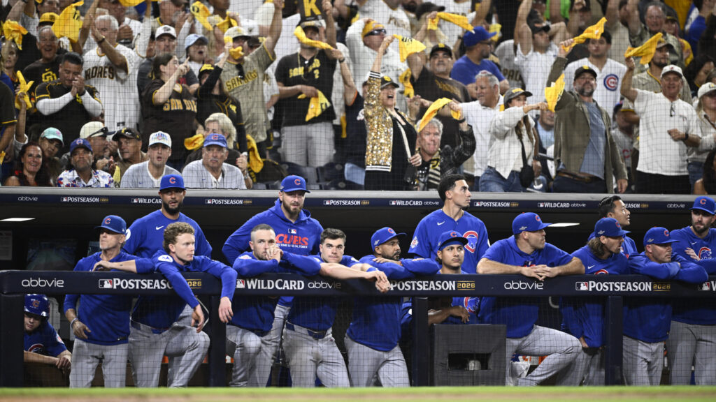 Sep 30, 2026; San Diego, California, USA; San Diego Padres fans cheer behind the Chicago Cubs dugout in the ninth inning during game two of the Wildcard round for the 2026 MLB Playoffs at Petco Park. Mandatory Credit: Denis Poroy-Imagn Images