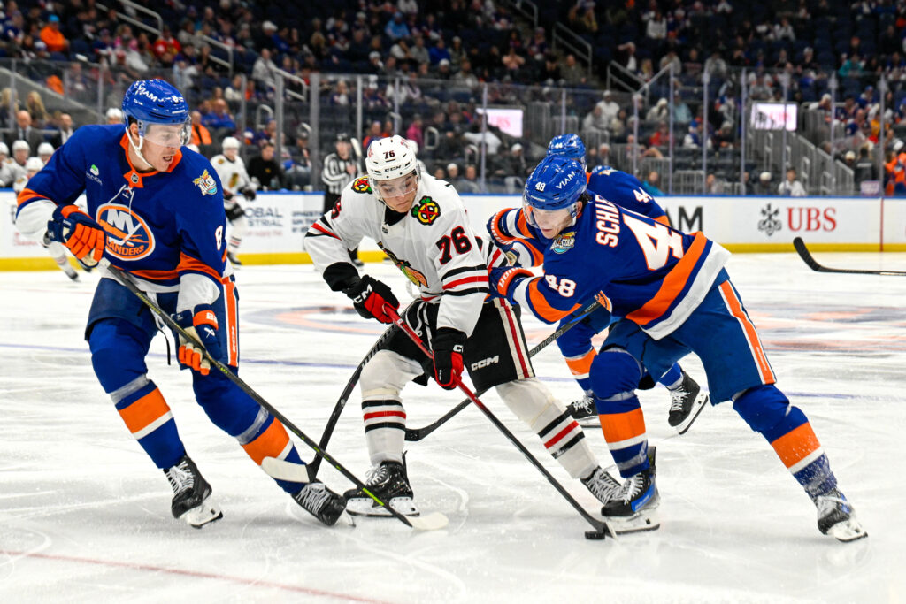 Oct 8, 2026; Elmont, New York, USA; New York Islanders defenseman Logan Stanley (8) and New York Islanders defenseman Matthew Schaefer (48) defend against Chicago Blackhawks left wing Nick Lardis (76) during the third period at UBS Arena. Mandatory Credit: Dennis Schneidler-Imagn Images