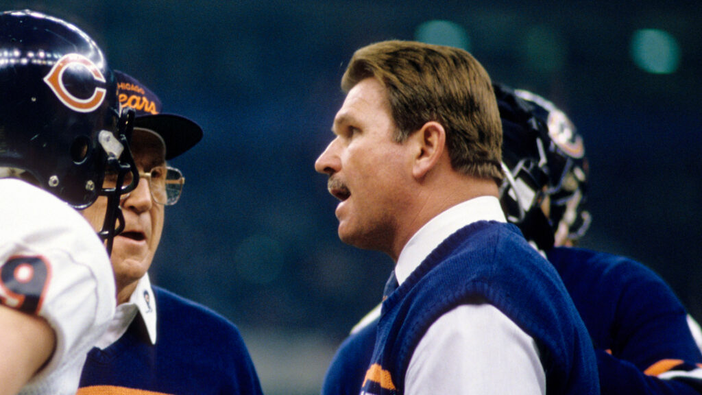 Jan 26, 1986; New Orleans, LA, USA; FILE PHOTO; Chicago Bears head coach Mike Ditka (right) and offensive coordinator Ed Hughes (center) talk to quarterback Jim McMahon (9) during Super Bowl XX against the New England Patriots at the Superdome. The Bears defeated the Patriots 46-10. Mandatory Credit: Manny Rubio-USA TODAY Sports