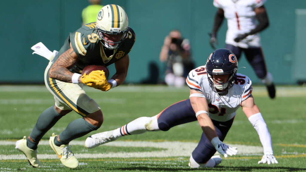 Oct 11, 2026; Green Bay, Wisconsin, USA; Green Bay Packers wide receiver Christian Watson (9) carries the ball defended by Chicago Bears safety Dillon Thieneman (31) during the third quarter at Lambeau Field. Mandatory Credit: Mike Dinovo-Imagn Images