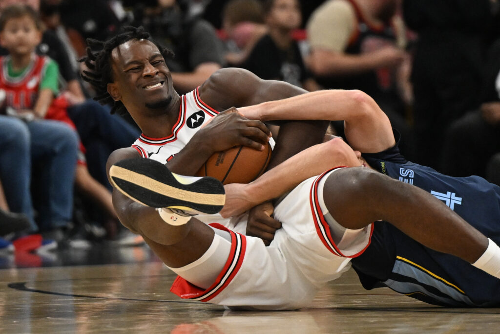 Oct 9, 2026; Chicago, Illinois, USA; Chicago Bulls forward Leonard Miller (11) grabs a loose ball away from Memphis Grizzlies guard Cam Spencer (24) during the second half at United Center.