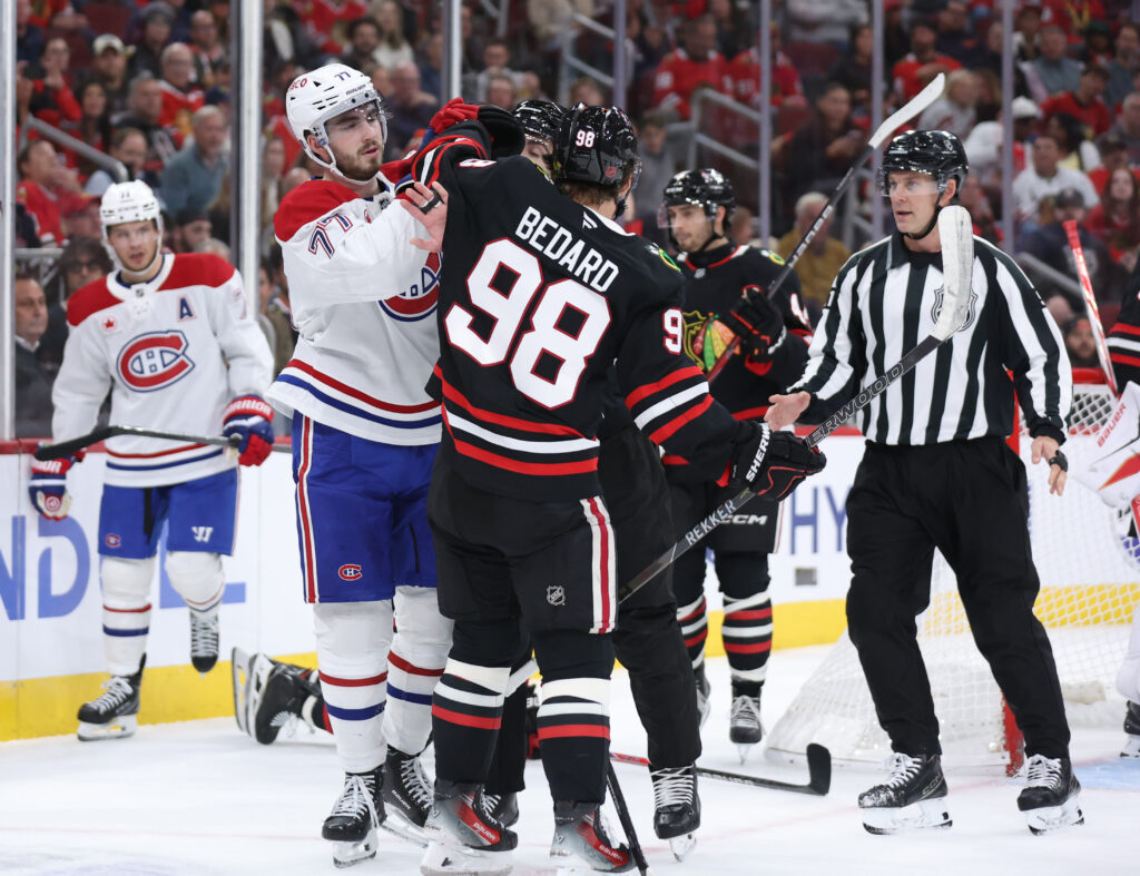 Oct 23, 2026; Chicago, Illinois, USA; Montreal Canadiens center Kirby Dach (77) fights with Chicago Blackhawks center Connor Bedard (98) during the second period at United Center. Mandatory Credit: Talia Sprague-Imagn Images