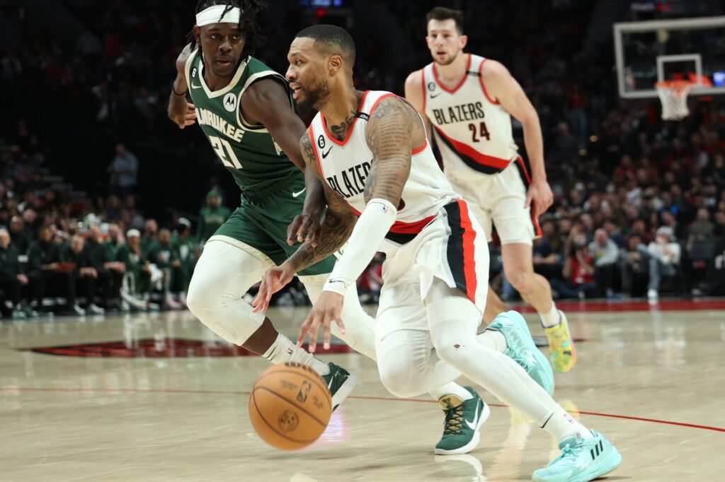 Damian Lillard driving past Jrue Holiday
