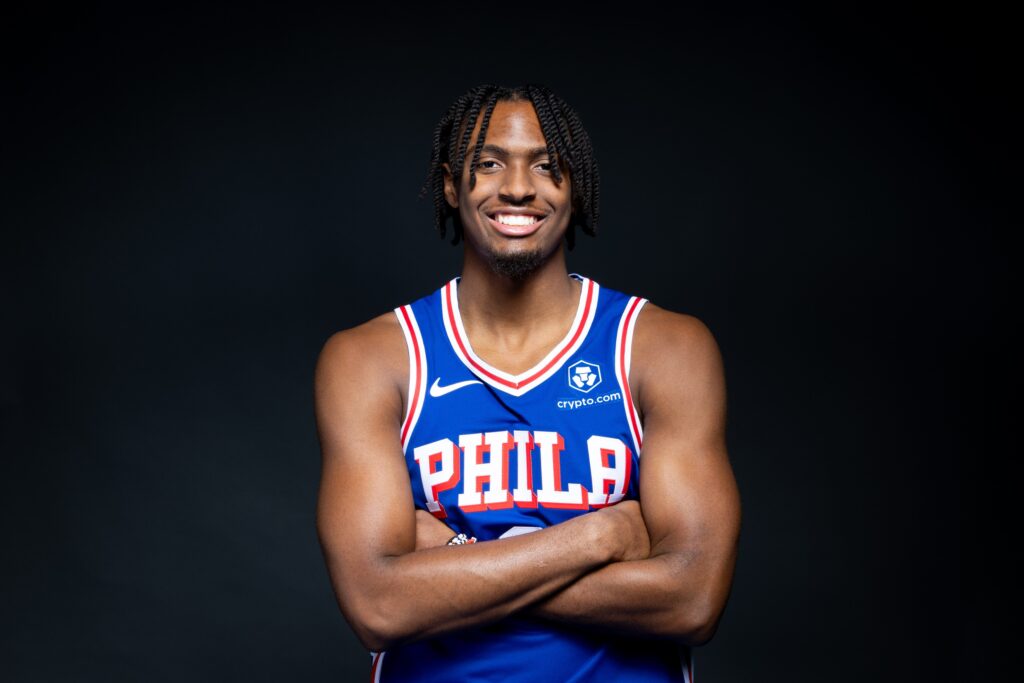 Tyrese Maxey posing at media day with his arms crossed.