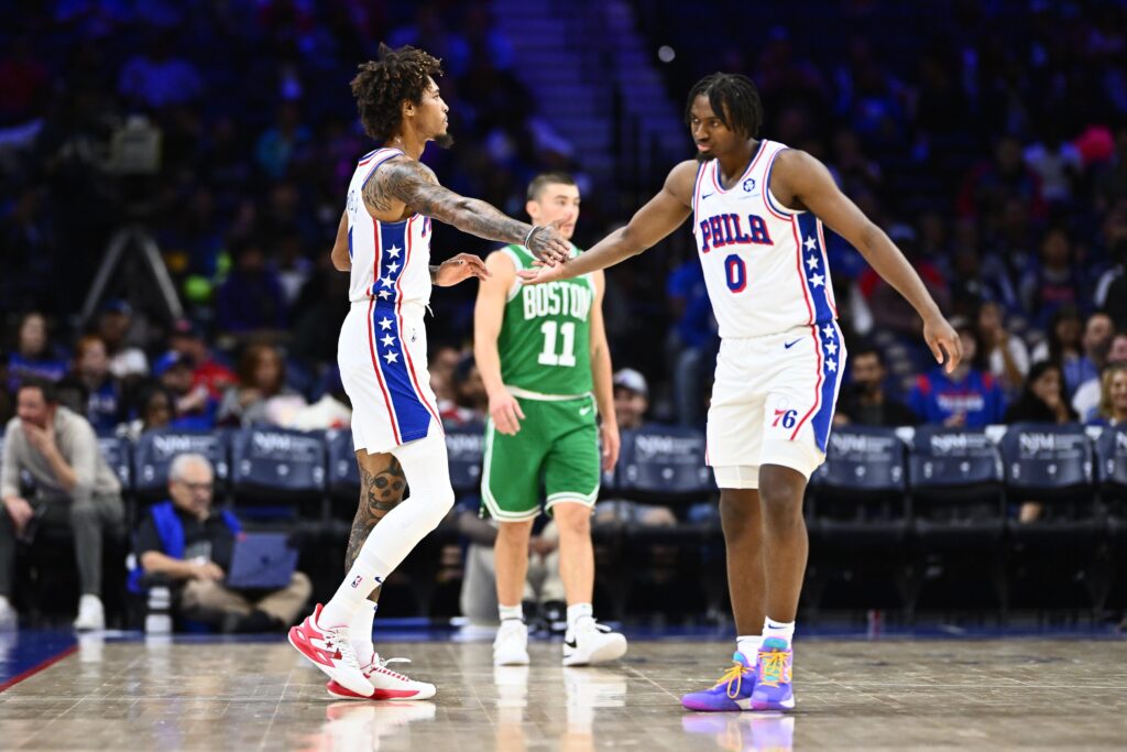 Kelly Oubre shaking hands with Tyrese Maxey.