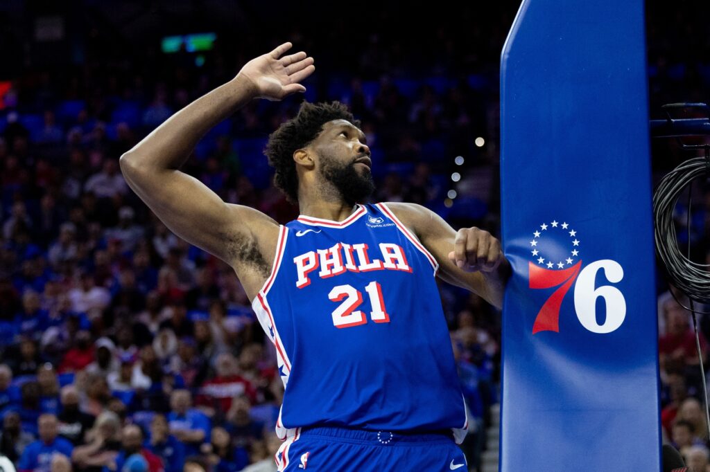 Joel Embiid smacks the Sixers' basket.