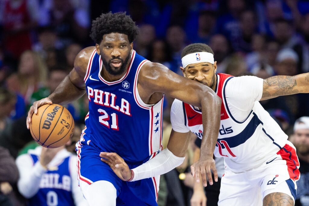 Joel Embiid driving past Daniel Gafford.