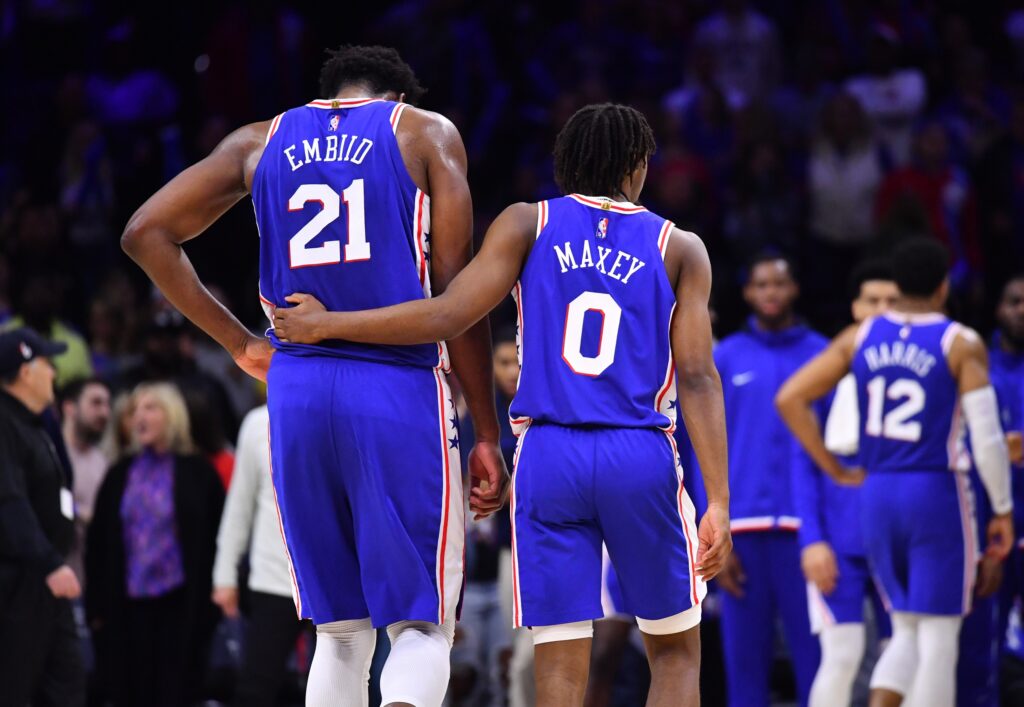 Tyrese Maxey with his arm around Joel Embiid.